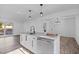 Open-concept kitchen with stainless appliances, granite island, and recessed lighting at 799 Kennesaw Dr, Forest Park, GA 30297