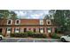 Charming brick townhouse featuring dormer windows, black shutters, and a well-maintained front landscape at 1261 Lavista Ne Rd # A-3, Atlanta, GA 30324