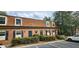 Brick townhouse displaying unique dormer windows, black shutters, and attractive front landscaping at 1261 Lavista Ne Rd # A-3, Atlanta, GA 30324