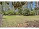 Expansive backyard featuring mature trees and a lush lawn, perfect for outdoor activities and relaxation at 1757 Colonial South Sw Dr, Conyers, GA 30094