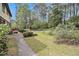 Well-maintained backyard with a patio, lush lawn, and mature landscaping for outdoor enjoyment at 1757 Colonial South Sw Dr, Conyers, GA 30094