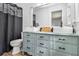 Bright bathroom with dual sinks, ample cabinets, modern fixtures, and shiplap wall at 1757 Colonial South Sw Dr, Conyers, GA 30094