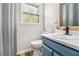Bathroom featuring a shower, toilet, and a sink on a blue vanity at 1757 Colonial South Sw Dr, Conyers, GA 30094