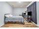 Bedroom with a plaid bedspread, featuring an entertainment center and dark curtains at 1757 Colonial South Sw Dr, Conyers, GA 30094