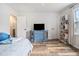 Bedroom featuring a blue dresser, a bookcase, and hardwood floors for a cozy atmosphere at 1757 Colonial South Sw Dr, Conyers, GA 30094