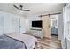 Bright, open bedroom with ceiling fan, wood floors and a barn door leading to the en suite bathroom at 1757 Colonial South Sw Dr, Conyers, GA 30094