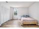 Clean bedroom boasting a window, closet and a twin bed on wood-look flooring, creating a cozy space at 1757 Colonial South Sw Dr, Conyers, GA 30094