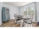 Bright dining room boasts a large window, wood floors, an antique hutch, and room to gather at 1757 Colonial South Sw Dr, Conyers, GA 30094
