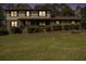 Charming two-story home with a covered front porch and well-maintained landscaping at twilight at 1757 Colonial South Sw Dr, Conyers, GA 30094