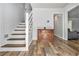 Bright foyer with hardwood floors and staircase at 1757 Colonial South Sw Dr, Conyers, GA 30094