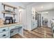 This is a great angle of this kitchen featuring stainless appliances, wood floors, and custom shelving at 1757 Colonial South Sw Dr, Conyers, GA 30094