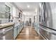 Spacious galley kitchen featuring stainless steel appliances, butcher block countertops, and wood floors at 1757 Colonial South Sw Dr, Conyers, GA 30094