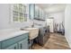 Large laundry room featuring modern washer/dryer, utility sink, and ample cabinet space at 1757 Colonial South Sw Dr, Conyers, GA 30094