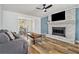 Cozy living room with a brick fireplace, hardwood floors, and a comfortable sofa at 1757 Colonial South Sw Dr, Conyers, GA 30094