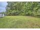 Expansive backyard with lush green lawn and mature trees, creating a private and serene outdoor space at 1945 Chateau Ln, Lithia Springs, GA 30122