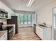 This kitchen features stainless steel appliances, granite countertops, white cabinetry and a window with natural lighting at 1945 Chateau Ln, Lithia Springs, GA 30122