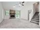 Spacious living room with a stone fireplace, sliding doors to the exterior, and staircase to upper level at 1945 Chateau Ln, Lithia Springs, GA 30122