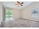 Spacious main bedroom featuring plush carpeting, natural lighting, and a sliding glass door to a private balcony at 1945 Chateau Ln, Lithia Springs, GA 30122