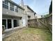 Enclosed backyard with a mix of grass, a small patio, and a weathered wooden fence for privacy at 4645 Valais Ct # 121, Alpharetta, GA 30022