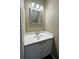 Cozy bathroom featuring a single sink vanity with a framed mirror and neutral wall color at 4645 Valais Ct # 121, Alpharetta, GA 30022