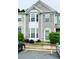 Inviting townhouse with a bay window, neutral siding, and well-maintained landscaping at 4645 Valais Ct # 121, Alpharetta, GA 30022