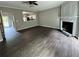 Open living room with hardwood floors, fireplace, and a view into the kitchen at 4645 Valais Ct # 121, Alpharetta, GA 30022