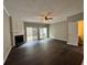 Spacious living room featuring dark wood floors, a fireplace, and sliding doors to the outside at 4645 Valais Ct # 121, Alpharetta, GA 30022