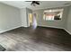 Living room with hardwood floors, ceiling fan, and view into the kitchen at 4645 Valais Ct # 121, Alpharetta, GA 30022