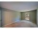 This bedroom features light-green walls, neutral carpeting, and a window at 154 Weatherly Way, Alpharetta, GA 30009