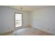 This empty bedroom has light walls, neutral carpet, and a window at 154 Weatherly Way, Alpharetta, GA 30009
