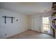 An empty bedroom with off-white walls, neutral carpeting, and a window with curtains at 154 Weatherly Way, Alpharetta, GA 30009