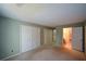 A bedroom featuring light-green walls and white closets plus an adjoining bathroom at 154 Weatherly Way, Alpharetta, GA 30009