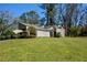 Charming single-story home featuring a carport, mature trees, and a well-manicured lawn at 154 Weatherly Way, Alpharetta, GA 30009