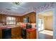 Functional kitchen includes wood cabinets, stainless steel appliances, and bright red countertops at 154 Weatherly Way, Alpharetta, GA 30009
