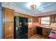 Well-appointed kitchen features wood cabinets, stainless steel appliances, and patterned wallpaper at 154 Weatherly Way, Alpharetta, GA 30009