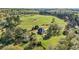 Breathtaking aerial view of a private residence showcasing a sprawling lawn, mature trees, and a serene rural setting at 240 Indian Creek Rd, Locust Grove, GA 30248