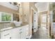 Beautiful bathroom featuring dual sinks, granite countertops, and slate floors at 240 Indian Creek Rd, Locust Grove, GA 30248