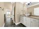 Bathroom with granite countertop vanity, vessel sink, and tile flooring, complemented by updated lighting and ample storage at 240 Indian Creek Rd, Locust Grove, GA 30248