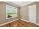 A bedroom featuring beautiful hardwood floors, natural light, and neutral paint at 240 Indian Creek Rd, Locust Grove, GA 30248