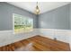 Bright empty bedroom showcasing hardwood floors and natural light, perfect for customization and comfort at 240 Indian Creek Rd, Locust Grove, GA 30248