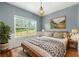 Cozy bedroom with a queen bed, natural light, and decor creating a relaxing and inviting space at 240 Indian Creek Rd, Locust Grove, GA 30248