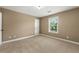 A carpeted bedroom with natural light, neutral paint and bright white trim at 240 Indian Creek Rd, Locust Grove, GA 30248