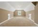 A large bonus room with carpet and two storage doors at 240 Indian Creek Rd, Locust Grove, GA 30248