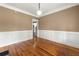 Dining room with chair railing, neutral walls, and gleaming hardwood floors at 240 Indian Creek Rd, Locust Grove, GA 30248