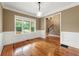 Dining room boasts a large window for natural light and classic wainscoting details at 240 Indian Creek Rd, Locust Grove, GA 30248