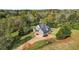 Stunning two-story home featuring a well-manicured lawn, neutral paint, an attached two-car garage, and mature trees at 240 Indian Creek Rd, Locust Grove, GA 30248