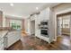 Kitchen featuring stainless steel appliances, white cabinets, and hardwood floors, creating a functional and stylish culinary space at 240 Indian Creek Rd, Locust Grove, GA 30248