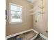 Compact laundry room featuring tile floors, shelving and a window for natural light at 240 Indian Creek Rd, Locust Grove, GA 30248
