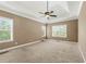 Spacious primary bedroom featuring a triple window and neutral decor at 240 Indian Creek Rd, Locust Grove, GA 30248