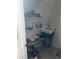 Storage closet with wire shelves, shoes, storage containers, laundry products, and beige walls at 5009 Duval Point Sw Way, Snellville, GA 30039